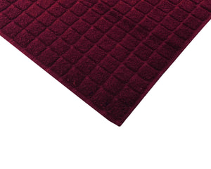 Opened dark red cotton bath mat by Idaman Suri