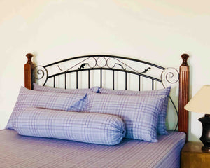 A bed with grey fitted bedsheets 4 pillows and 1 bolster