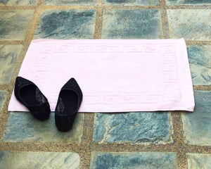 Laid out light pink cotton bath mat by Idaman Suri